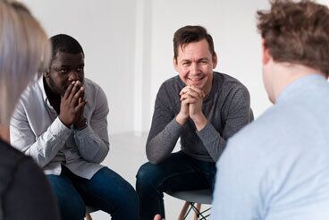 People sitting in rehab meeting